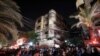 Palestinians gather in front of a building as firefighters extinguish a blaze that broke out in one of the apartments in the Jabaliya refugee camp in the northern Gaza strip, Nov. 17, 2022.