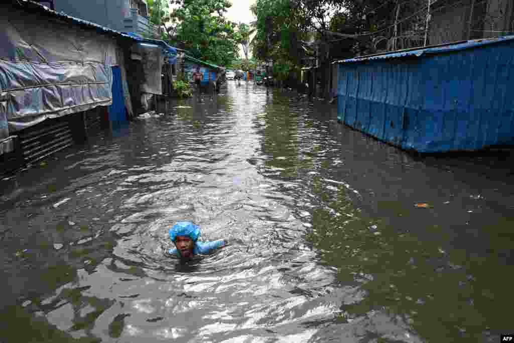 A boy swims through flood waters after heavy rain in Yangon, Myanmar.