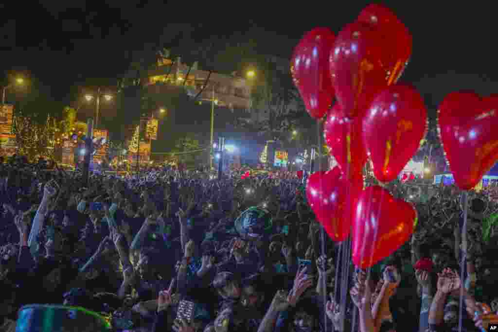 People celebrate New Year's at a promenade in Mumbai, India, Jan. 1, 2024.