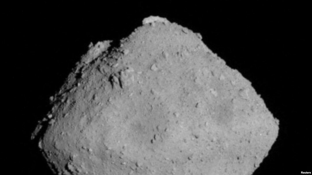 The carbonaceous asteroid Ryugu is seen from a distance of about 12 miles (20 km) during the Japanese Space Agency's Hayabusa2 mission on June 30, 2018.