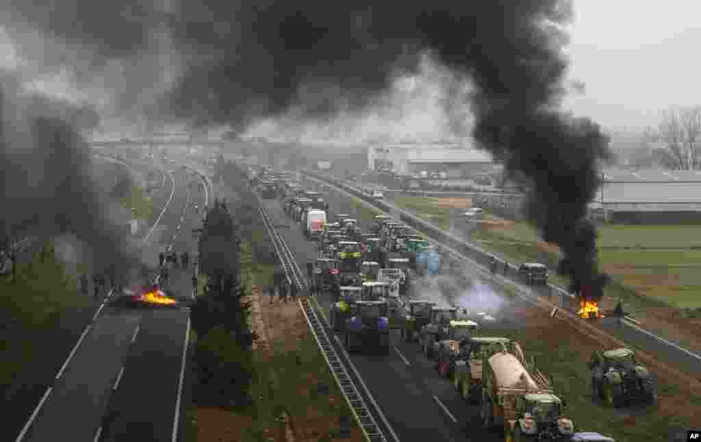 Farmers block a highway during a protest near Mollerussa, northeast Spain. Farmers across Spain have staged tractor protest to demand of changes in European Union policies and funds and measures to combat production cost hikes. 