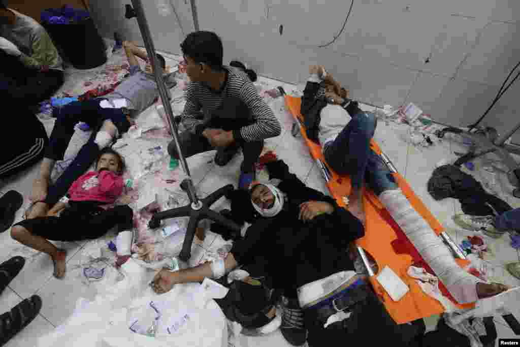 Wounded Palestinians are assisted at Nasser hospital, following Israeli strikes on Ma'an school east of Khan Younis, in Khan Younis in the southern Gaza Strip.