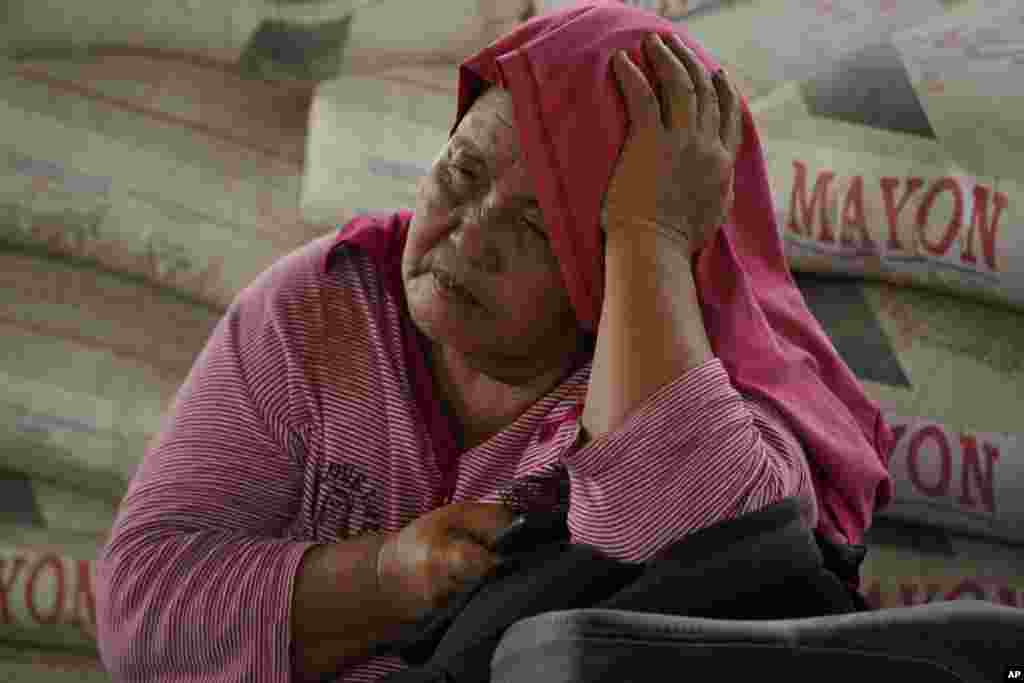 An evacuee rests at an evacuation center in Guinabotan, Albay province, northeastern Philippines. The Philippines' most active volcano was gently spewing lava down its slopes, alerting tens of thousands of people they may have to quickly flee a violent and life-threatening explosion.