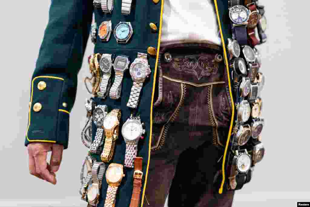 A visitor with several watches strapped to his blazer is pictured at the Watches and Wonders fair in Geneva, Switzerland.