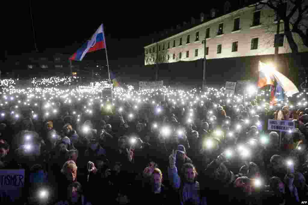 People take part in a demonstration to protest criminal code reforms to be passed despite sharp criticism from the EU, in front of the Slovak parliament in Bratislava, Slovakia. The changes, which prompted a wave of anti-government protests, include easing the penalties for corruption and economic offences.