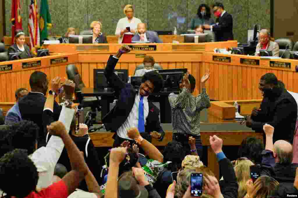 Justin J. Pearson gestures after a vote for his reinstatement by the Shelby County Commission, days after the Republican majority Tennessee House of Representatives voted to expel him and Rep. Justin Jones for their roles in a gun control demonstration on the statehouse floor, in Memphis, Tennessee, April 12, 2023. 