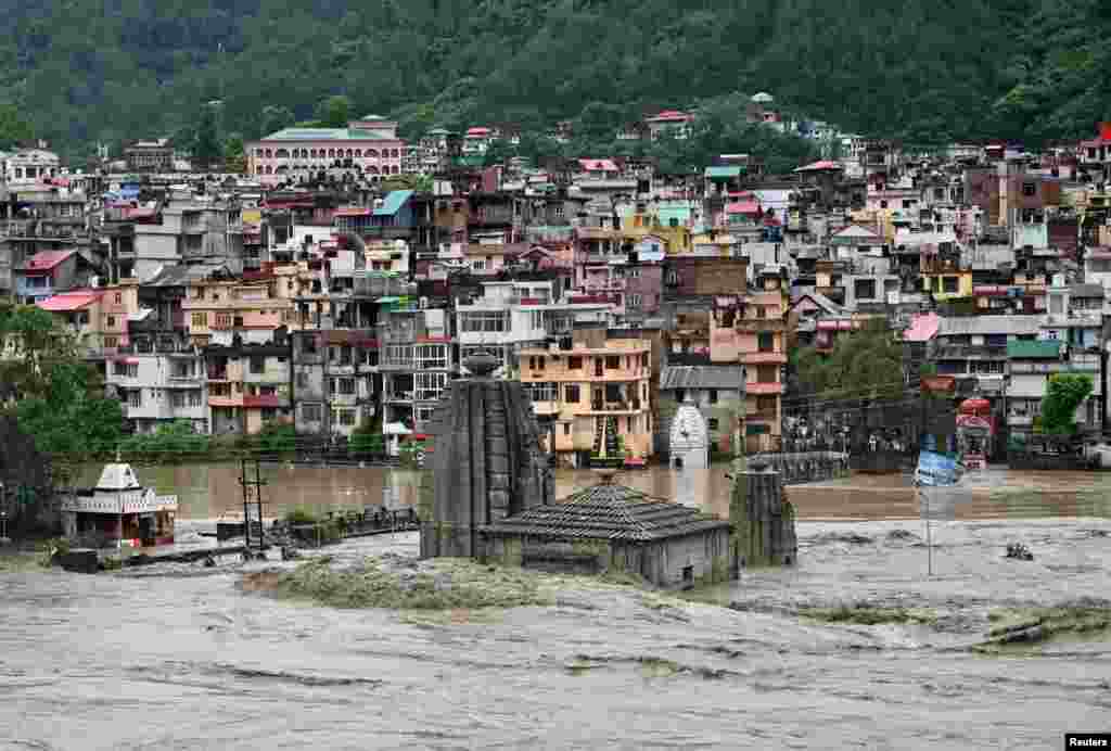 A submerged temple is pictured as the river Beas overflows following heavy rains in Mandi in the northern state of Himachal Pradesh, India.