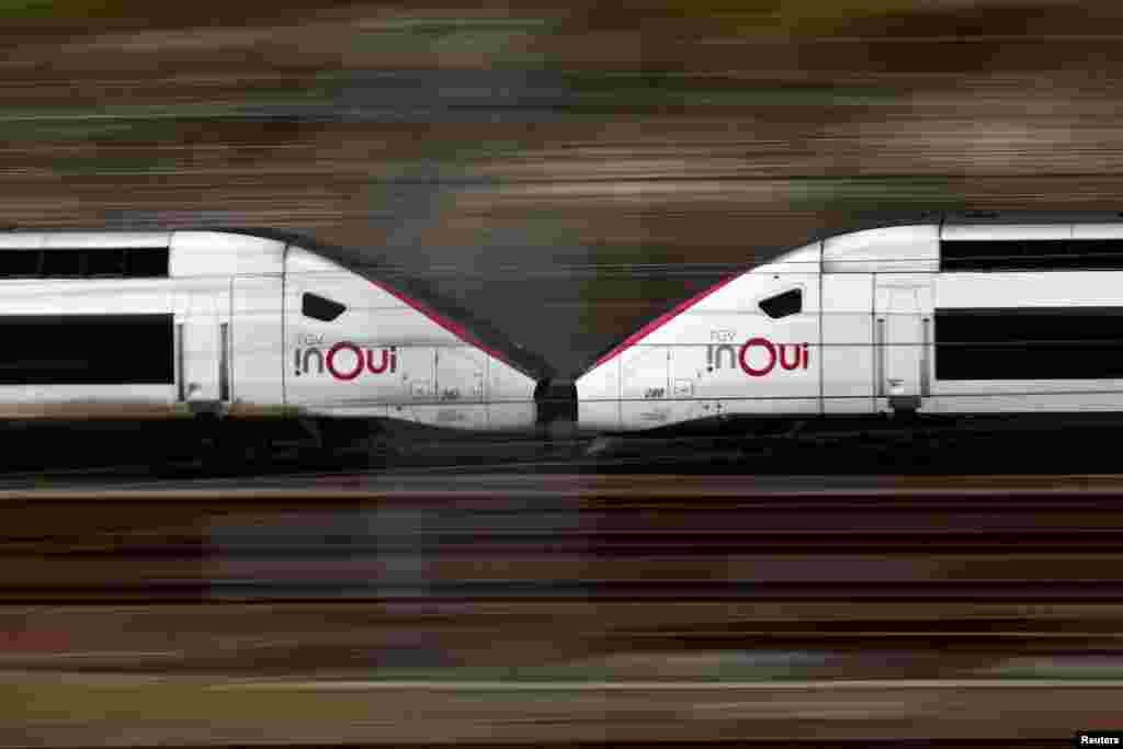 A TGV high speed train drives past a SNCF depot station in Charenton-le-Pont near Paris ahead of a national strike by French SNCF (French state-owned railway company) controllers in France.