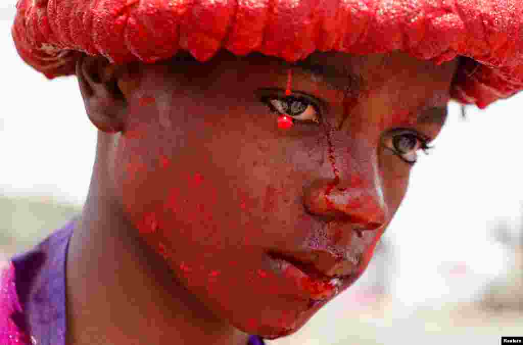 Kenyan Catholic devotee Joseph Browlins, 14, portraying Jesus Christ, is seen as he performs the re-enactment of the crucifixion of Jesus Christ, during Good Friday procession in Kibera settlement of Nairobi.
