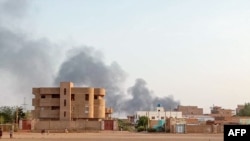 FILE - Smoke billows in the distance around Khartoum's Bahri district amid ongoing fighting in Sudan's capital, July 14, 2023. 