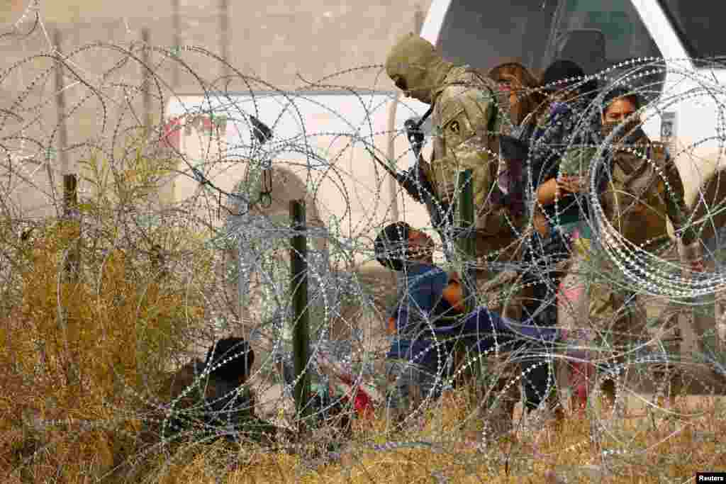 A migrant child seeking asylum pleads a member of the Texas National Guard to be allowed to enter the United States, as seen from Ciudad Juarez, Mexico, Jan. 30, 2024.