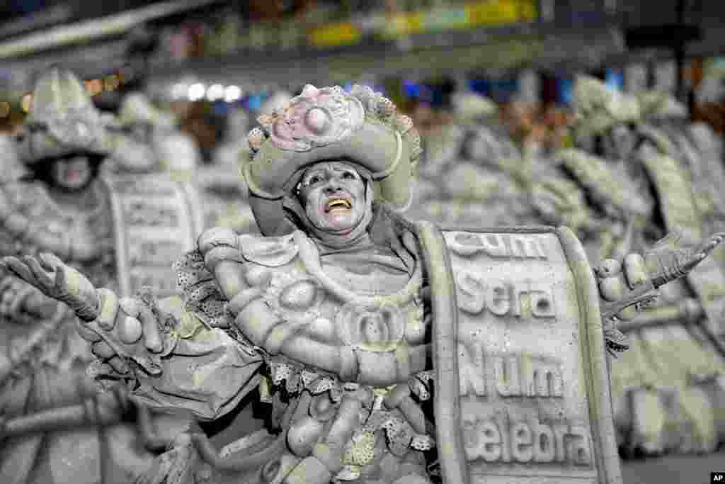 A dancer from the Mocidade Alegre samba school performs during a Carnival parade in Sao Paulo, Brazil.