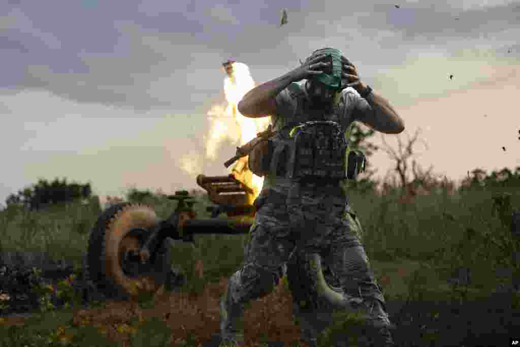 A Ukrainian serviceman of the 3rd Assault Brigade fires a 122mm mortar towards Russian positions at the front line, near Bakhmut, Donetsk region, July 2, 2023.