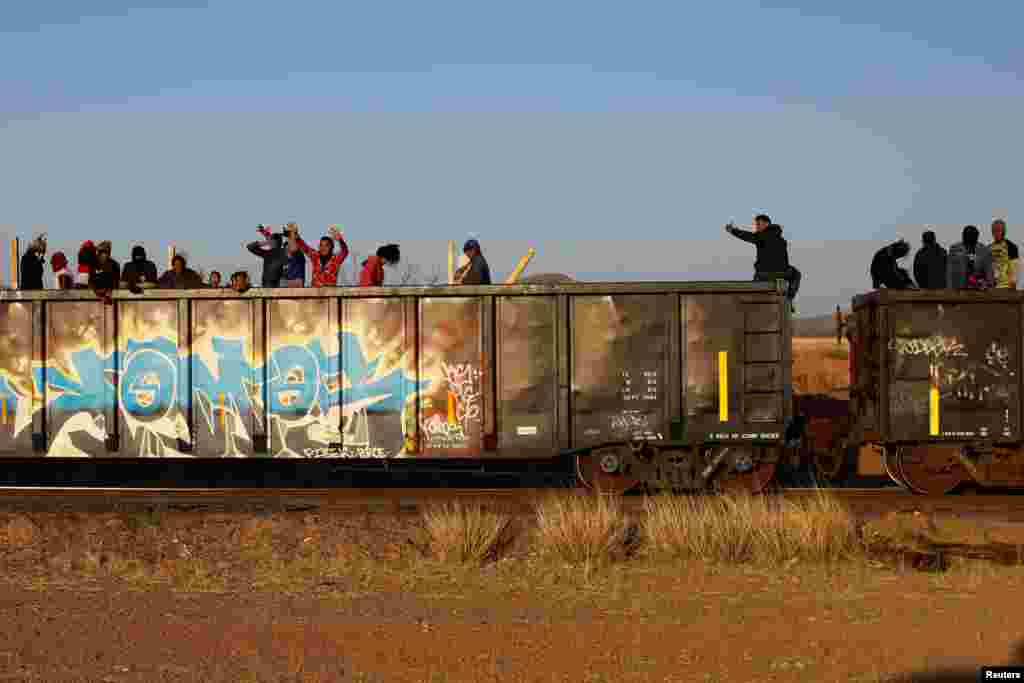 Migrants ride on a train towards Ciudad Juarez, in La Escuadra, Chihuahua, Mexico. March 28, 2023.