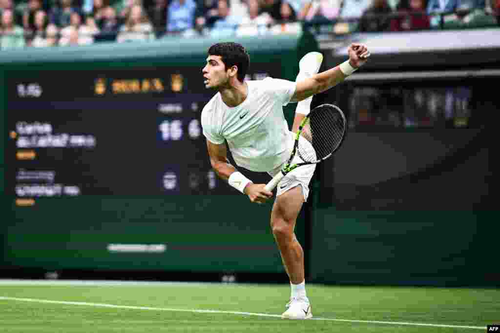 Spain's Carlos Alcaraz serves the ball to France's Jeremy Chardy during their men's singles tennis match on the second day of the 2023 Wimbledon Championships at The All England Tennis Club in Wimbledon, London.