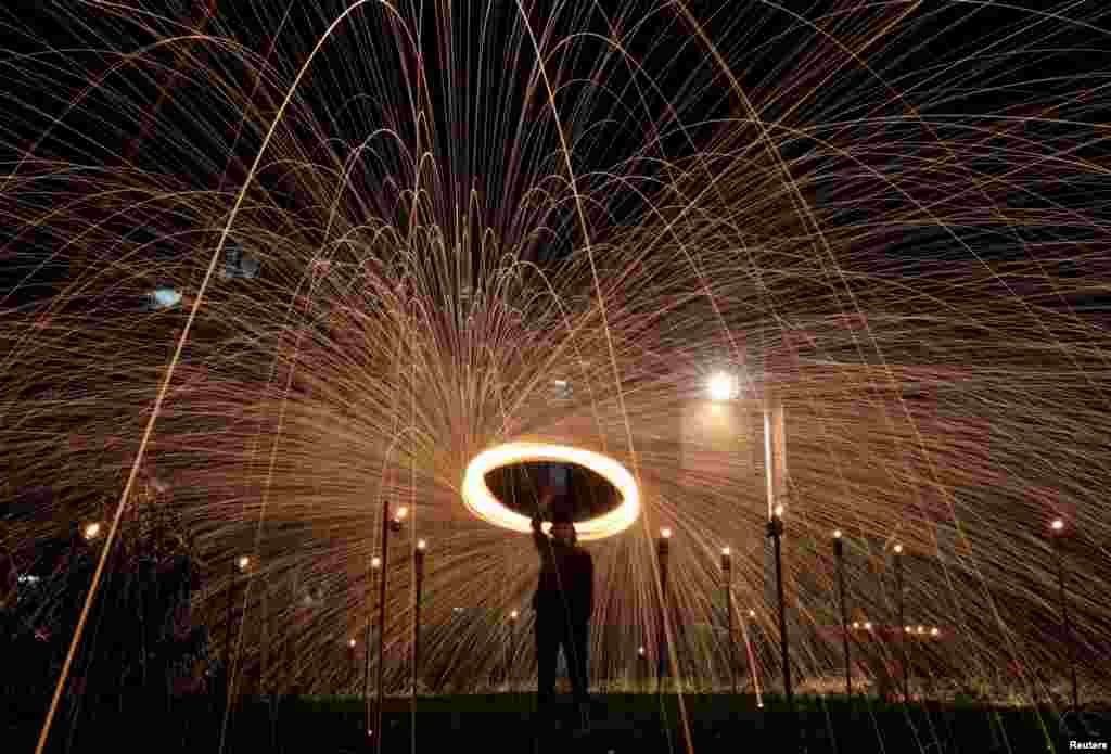 Malaysian Muslim Fadzlie Mohamad swings a sparkler on the last ten days of Muslim holy month of Ramadan in Kuala Lumpur, Malaysia, April 16, 2023.