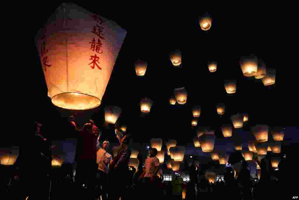 Tourists release sky lanterns during the Pingxi Lantern Festival in New Taipei City, Feb. 17, 2024.