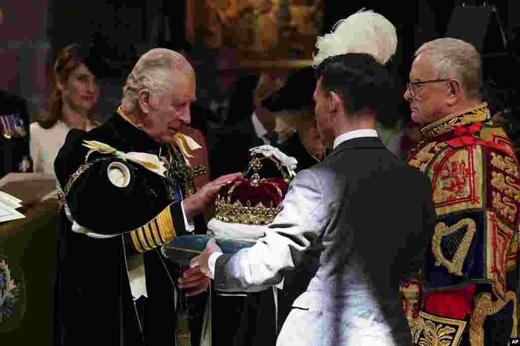 Britain's King Charles III is presented with the Crown of Scotland during the National Service of Thanksgiving and Dedication for King Charles III and Queen Camilla, and the presentation of the Honours of Scotland, at St Giles' Cathedral, in Edinburgh.