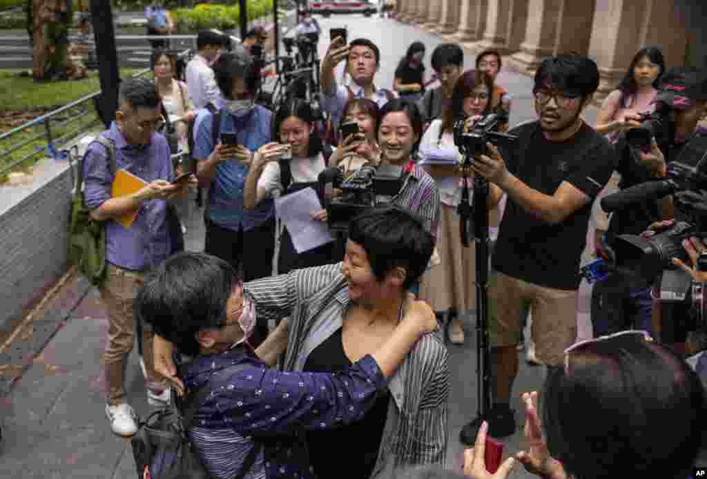 Award-winning Hong Kong journalist Bao Choy, front right, hugs Sham Yee-lan, former Hong Kong Journalists Association chairperson, after being cleared by the city's top court in Hong Kong.