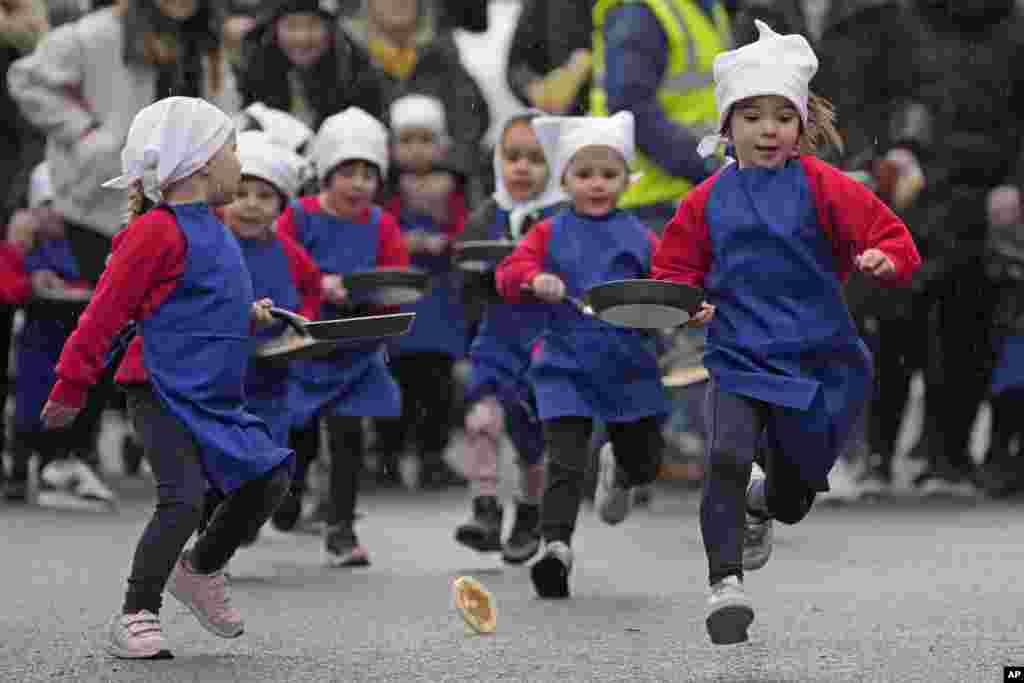 Schoolchildren from local schools take part in the children's races prior to the annual Pancake race in the town of Olney, in Buckinghamshire, England.