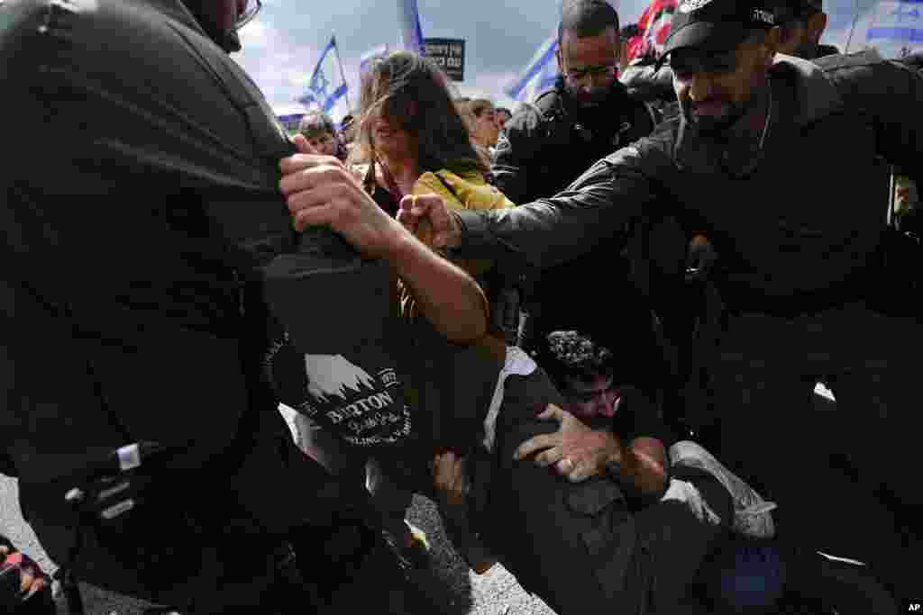 Israelis scuffles with police during a protest against Prime Minister Benjamin Netanyahu's judicial overhaul plan outside the parliament in Jerusalem.