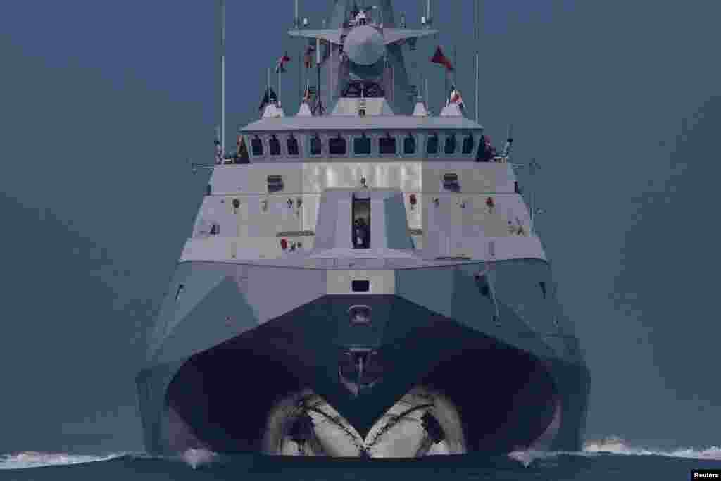 Members of Taiwan's Navy onboard a Tuo Chiang-class corvette participate in a drill on the waters near a military base in Kaohsiung.