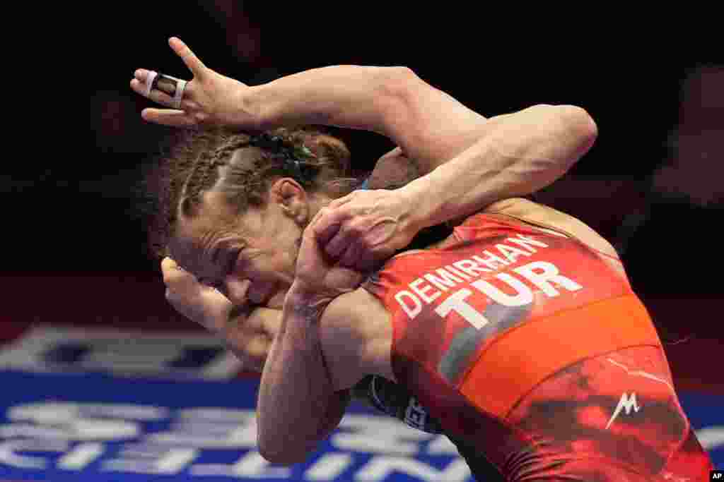 Azerbaijan's Mariya Stadnik, left, competes with Turkey's Evin Demirhan in a women's freestyle 50 kg category gold medal wrestling match during the European Wrestling Championships, in Bucharest, Romania.