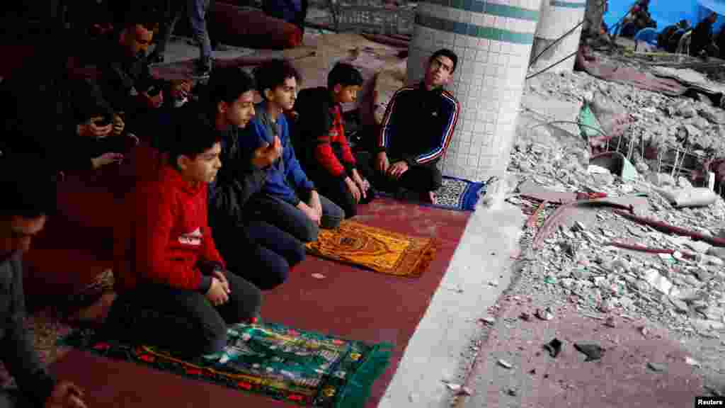 Palestinians perform Friday prayers at the ruins of a mosque destroyed in Israeli strikes amid the ongoing conflict between Israel and the Palestinian Islamist group Hamas, in Rafah in the southern Gaza Strip.