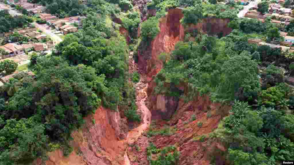 An aerial view shows a hole created by landslides in past years and increased due to recent heavy rains, in Buriticupu in Maranhao state Brazil, March 28, 2023.