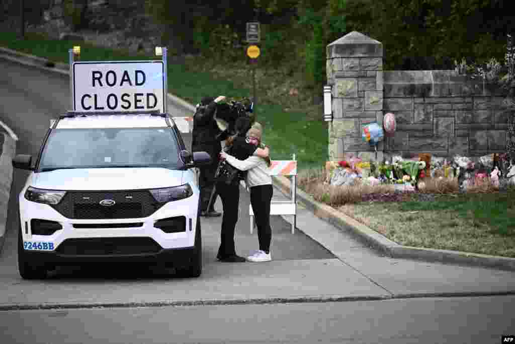 A woman hugs a police officer at the entrance of the Covenant School at the Covenant Presbyterian Church, in Nashville, Tennessee. A heavily armed former student killed three young children and three staff in what appeared to be a carefully planned attack at a private elementary school in Nashville, before being shot dead by police.