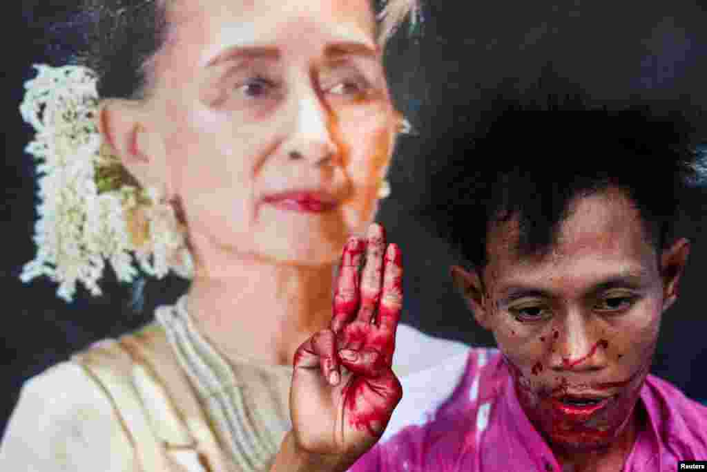 A protester with fake blood on his body raises a three-finger salute in a demonstration to mark the third anniversary of Myanmar’s 2021 military coup, outside of the United Nations office in Bangkok, Thailand.