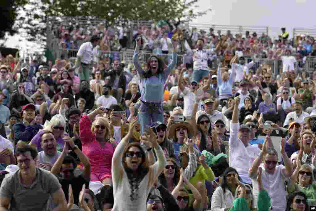 Spectators watch the men's singles final between Spain's Carlos Alcaraz and Serbia's Novak Djokovic on day fourteen of the Wimbledon tennis championships in London.