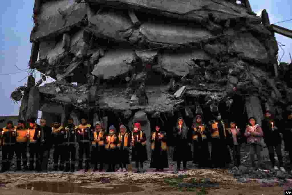 Members of the Syrian Civil Defense along with survivors of last year's catastrophic earthquake mark the one-year anniversary of the earthquake that destroyed northern Syria and Turkey, in Jindayris in the northwest of Syria's Aleppo province, Syria.