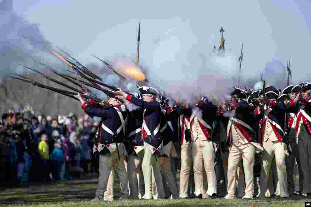 Members of Alpha Company, 3d U.S. Infantry Regiment (The Old Guard), give a firing demonstration on the Bowling Green of George Washington's Mount Vernon in Mount Vernon, Virginia.
