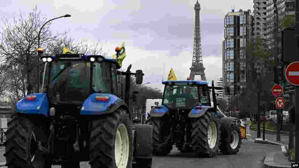 French farmers drive tractors during a demonstration of the Coordination Rurale agricultural union ahead of the opening of the 60th International Agriculture Fair, on the Quai Andre Citroen, Paris.