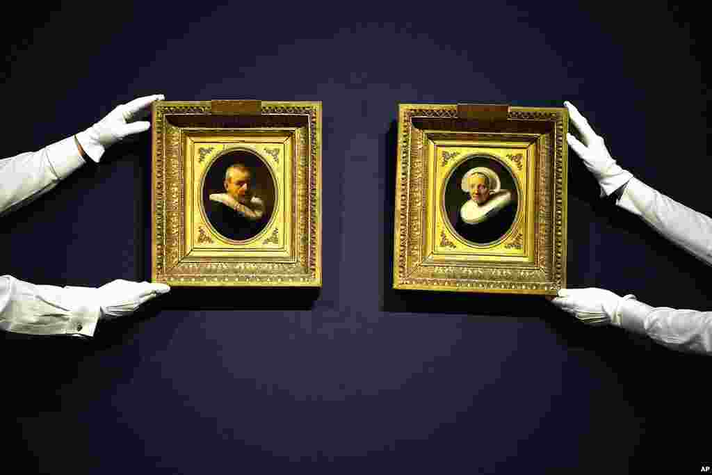 The landmark re-discovered Rembrandt portrait of Jan Willemsz van der Pluym and Jaapgen Carels, both rare and intimate portrayals of relatives of the artist and the last known pair of portraits by Rembrandt to remain in private hands, are adjusted by Christies auction house staff in London. Both of Rembrandt's portraits are at auction 200 years after they were last seen at Christie's with an estimate of £5,000,000 - 8,000,000. ($6,300,000 - 10,000,000 USD).