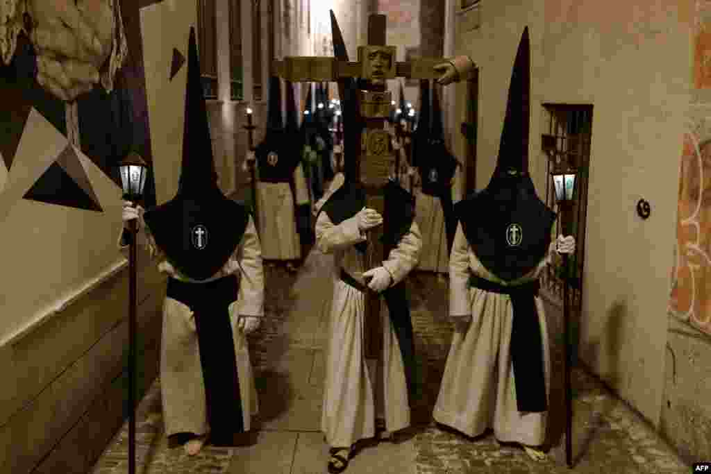 Penitents members of the "Hermandad Penitencial de las Siete Palabras" procession are seen during Holy Week in the northwestern Spanish city of Zamora. Christian believers around the world mark the Holy Week of Easter in celebration of the crucifixion and resurrection of Jesus Christ. 