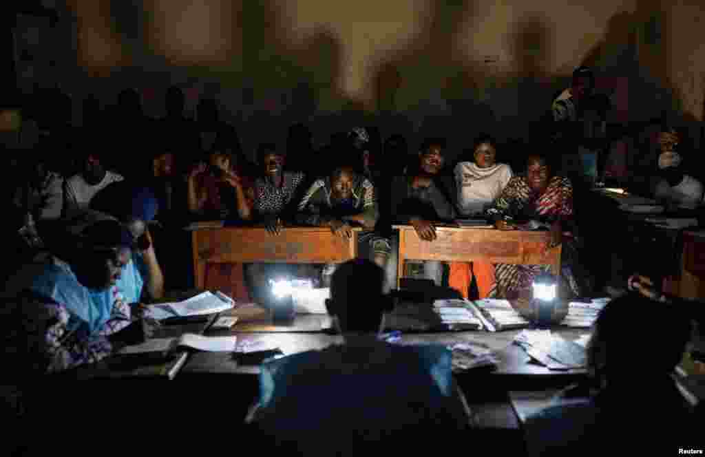 Independent National Electoral Commission (CENI) officials and polling agents count ballot papers at a polling centre following the presidential election in Goma, North Kivu province, Democratic Republic of Congo, Dec. 20, 2023.