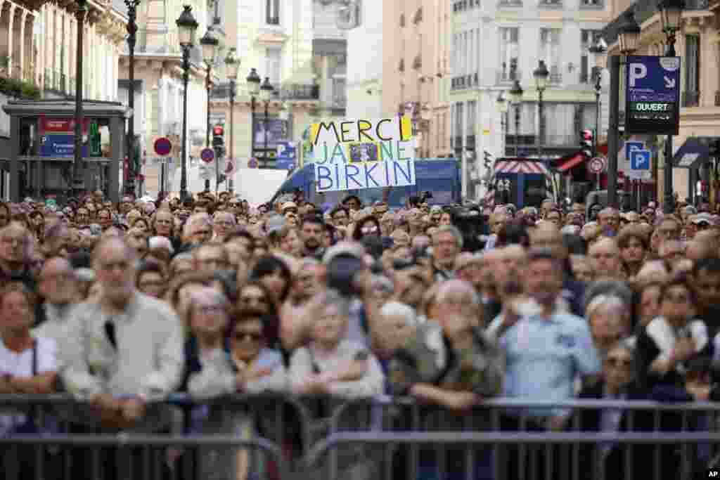 A crowd waits outside the Saint-Roch church during Jane Birkin's funerals ceremony in Paris, France. Actor and singer Jane Birkin, who made France her home and charmed the country with her English grace, natural style and social activism, has died last week at age 76. 