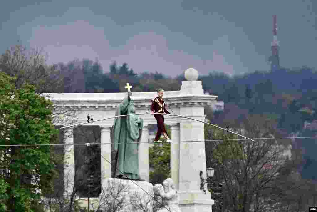 Hungarian high-wire artist Laszlo Simet Jr, 63, walks on a tightrope over the Danube in downtown Budapest, April 15, 2023.