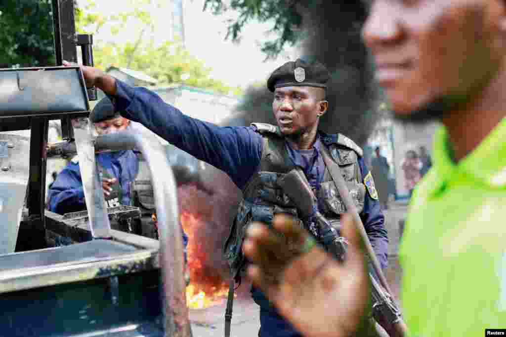 A police officer reacts during a protest near the U.N. mission in Congo MONUSCO headquarters in downtown Kinshasa, Democratic Republic of Congo.