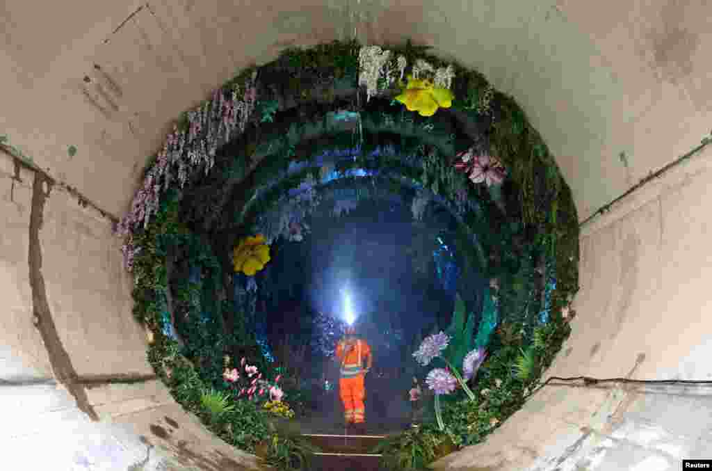 Engineer Jason Lyon views Loo Garden, a temporary subterranean garden designed to represent a future healthier River Thames, in London, Britain, on June 29, 2023. The section of the Thames Tideway Tunnel — commonly known as the "Super Sewer" — is a 25-kilometer tunnel being built across London under and along the River Thames to deal with combined sewer overflows currently polluting the river.