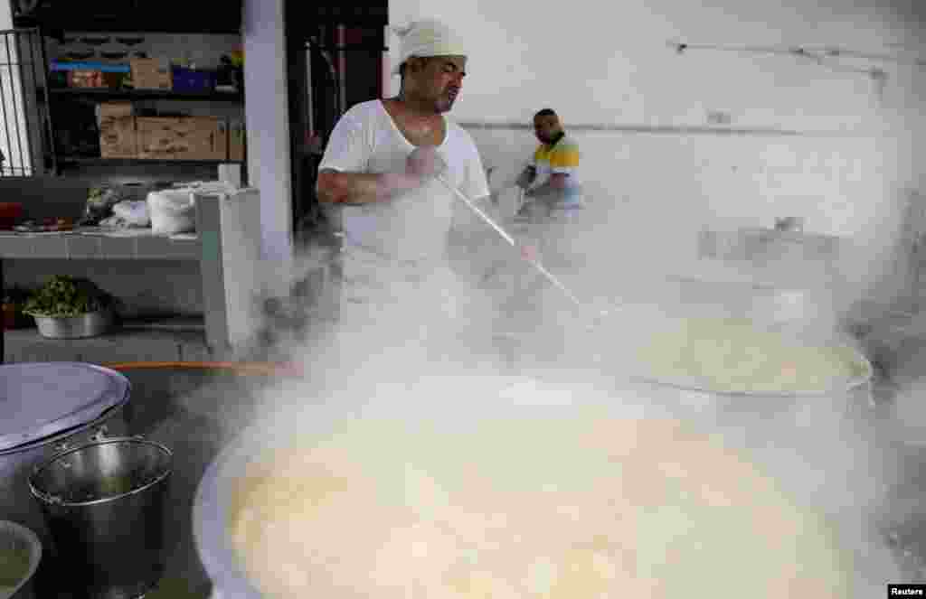Cook, Hamid Sadakathullah, prepares the food for the community to break their fast on the first day of Ramadan at a mosque in Kuala Lumpur, Malaysia.