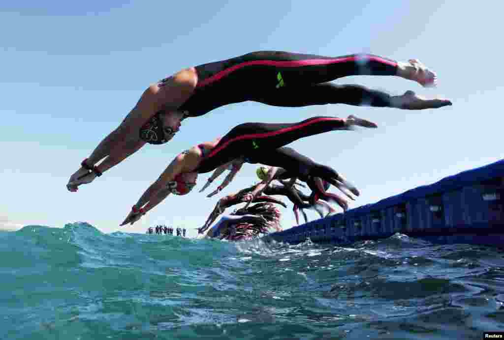Swimmers compete during the women's 5km open water final at the World Aquatics Championships in Doha, Qatar.