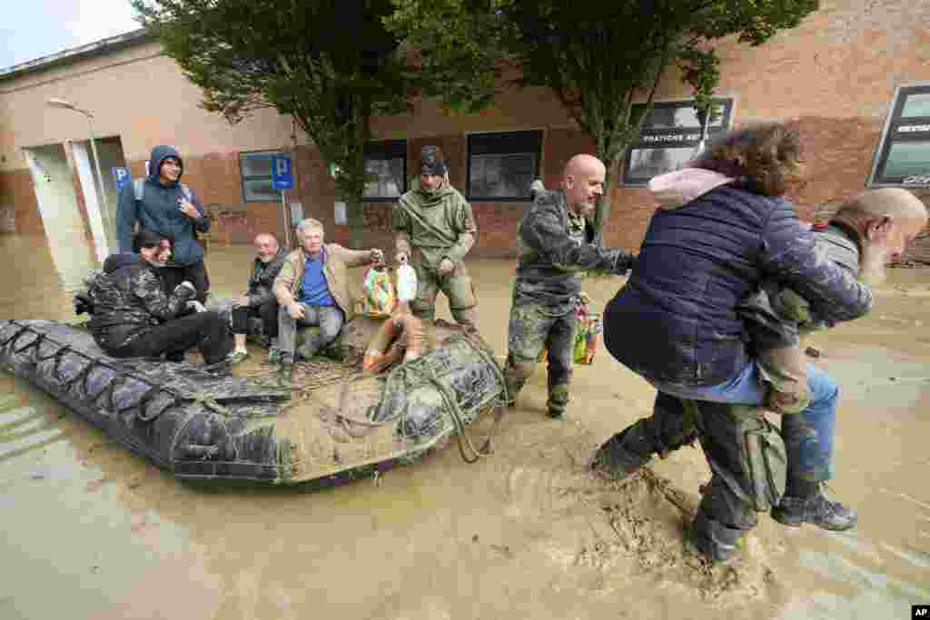People are rescued in Faenza, Italy, May 18, 2023. Exceptional rains in a drought-struck region of northern Italy swelled rivers over their banks, killing at least nine people, forcing the evacuation of thousands. 
