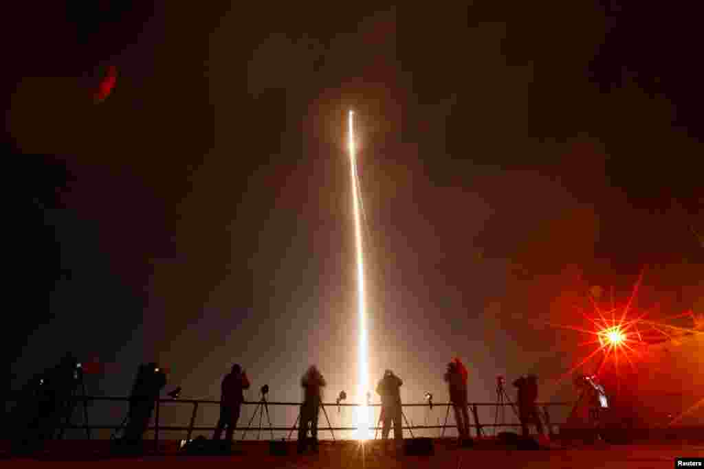People take photographs during the launch of Boeing-Lockheed joint venture United Launch Alliance's next-generation Vulcan rocket on its debut flight from Cape Canaveral, Florida.