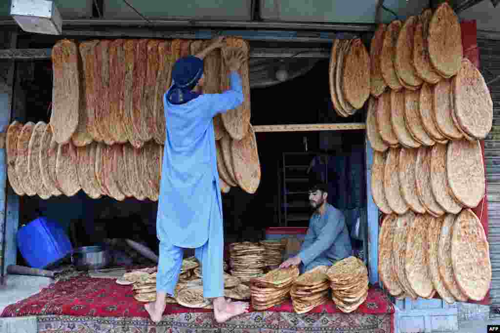 Vendors selling bread wait for customers in Quetta, Pakistan.