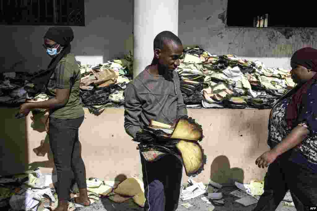 Archival and documentation students sift through burned documents at the Cheikh Anta Diop University in Dakar, Senegal, in an effort to salvage them. Tens of thousands of student archives dating back to 1957 were burned during a protest that broke out June 1, after opposition leader Ousmane Sonko was sentenced to two years in prison.
