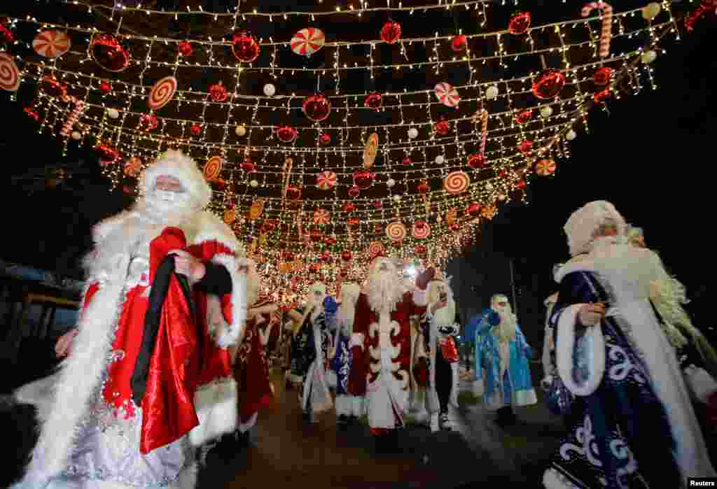 Participants dressed as Ayaz Ata (Father Frost) - the Kazakh equivalent of Santa Claus, take part in a procession through city streets while marking the New Year and Christmas season in Almaty, Kazakhstan.