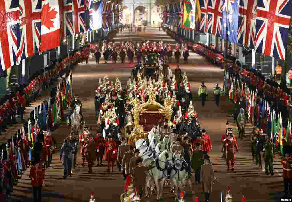 The Gold State Coach is ridden alongside members of the military during a full overnight dress rehearsal of the Coronation Ceremony of Britain’s King Charles and Camilla, Queen Consort in London, Britain.